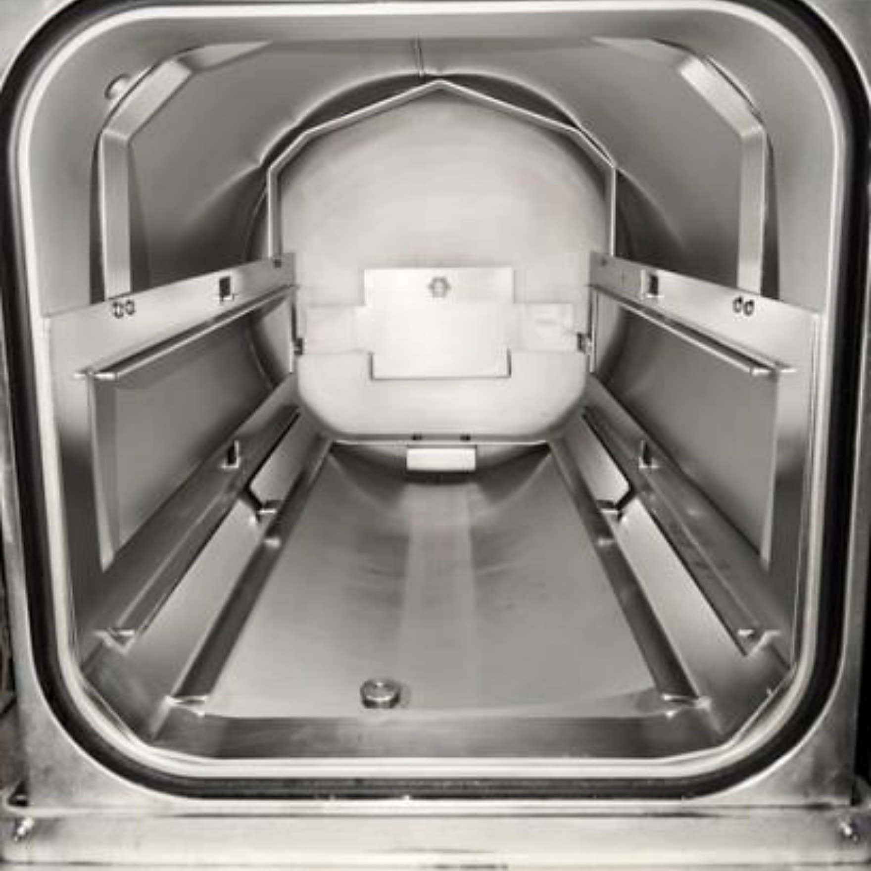 The same sterilizer chamber after cleaning, with restored stainless surfaces