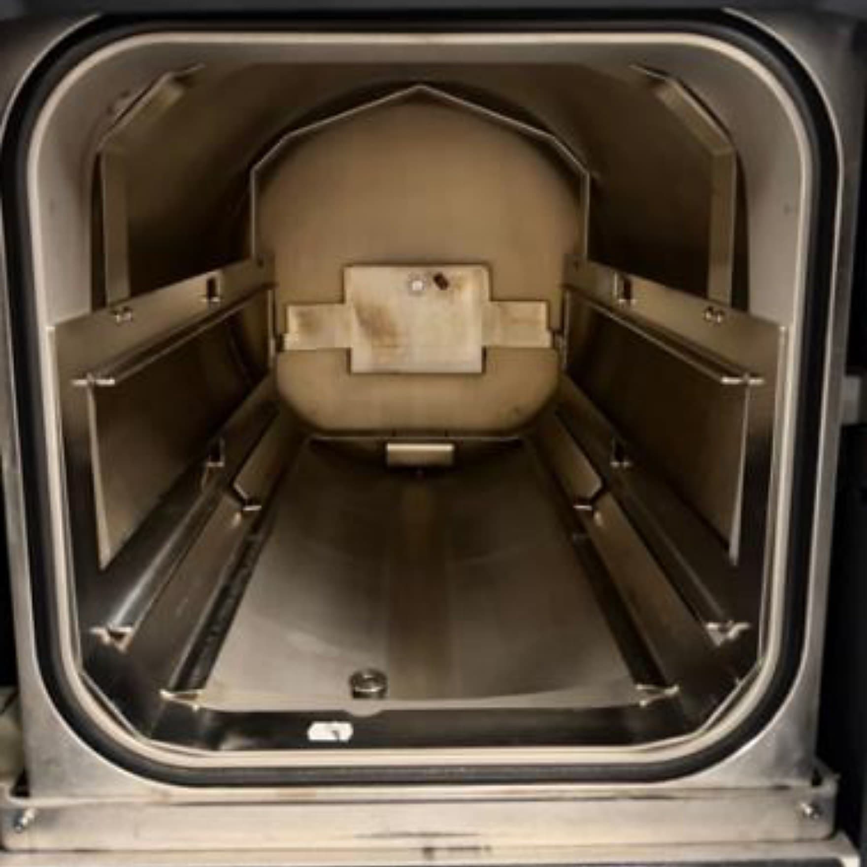 A discolored sterilizer chamber interior before cleaning by Maximo Medical