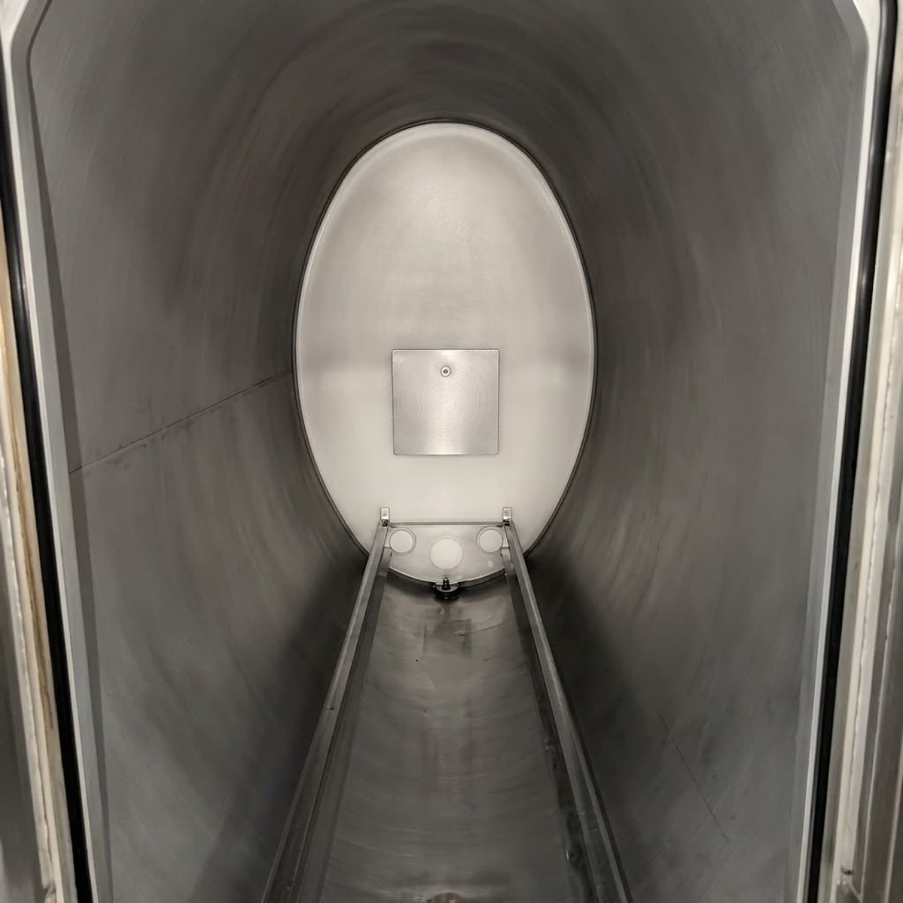 The same sterilizer chamber after cleaning, with restored stainless surfaces