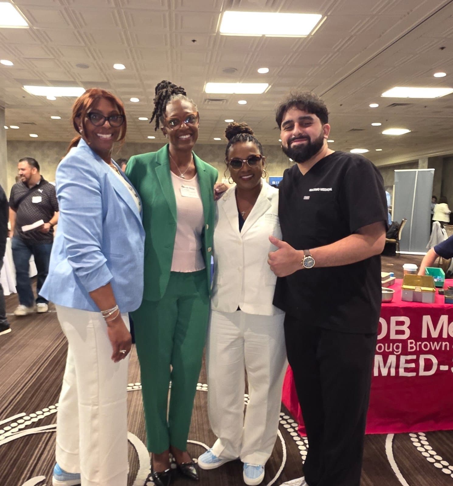 A Maximo Medical team member with colleagues at a healthcare conference
