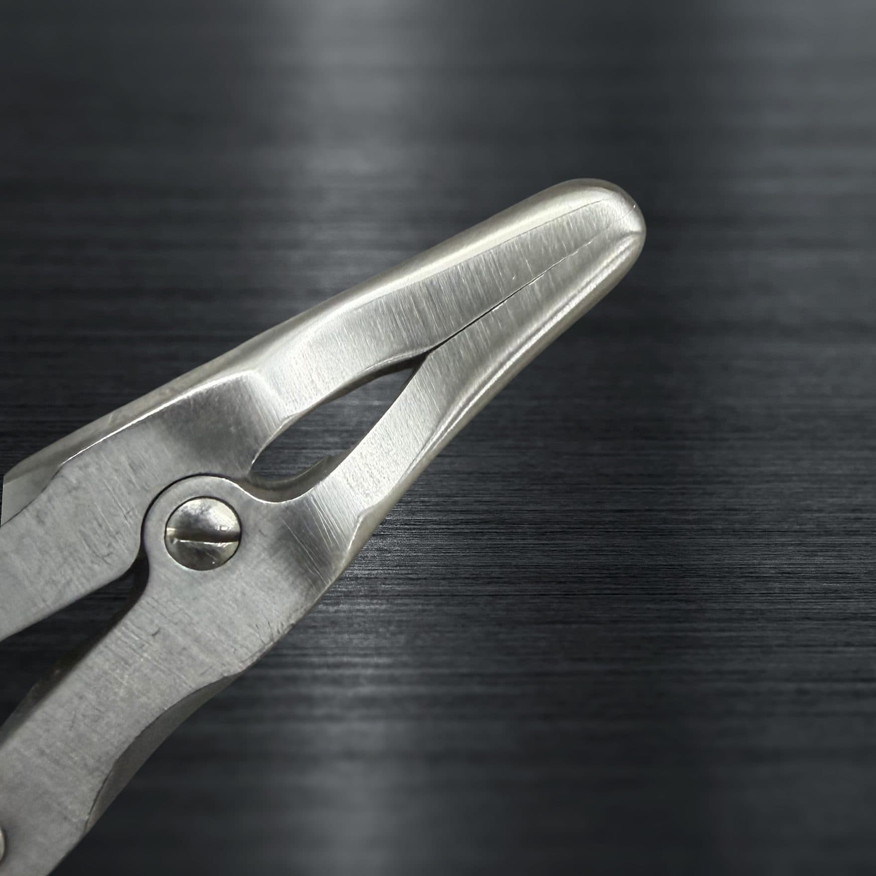 The same surgical instrument after repair, cleaned and restored to a bright finish