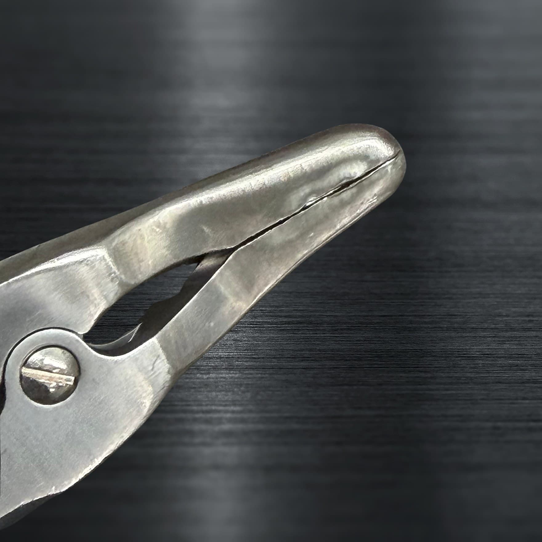 Surgical instrument before a Maximo Medical repair, showing wear and tarnish on the stainless surface