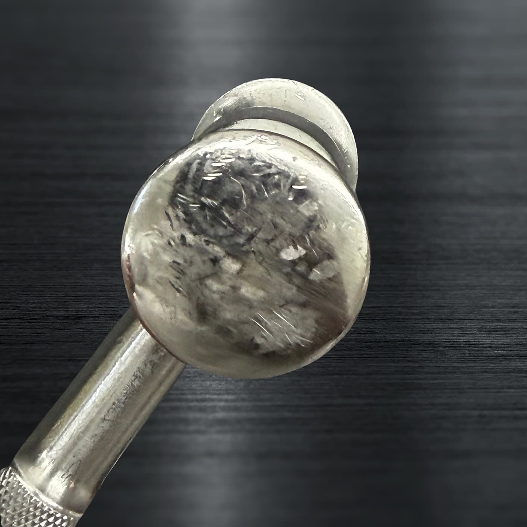 A surgical instrument before Maximo Medical service, with surface wear